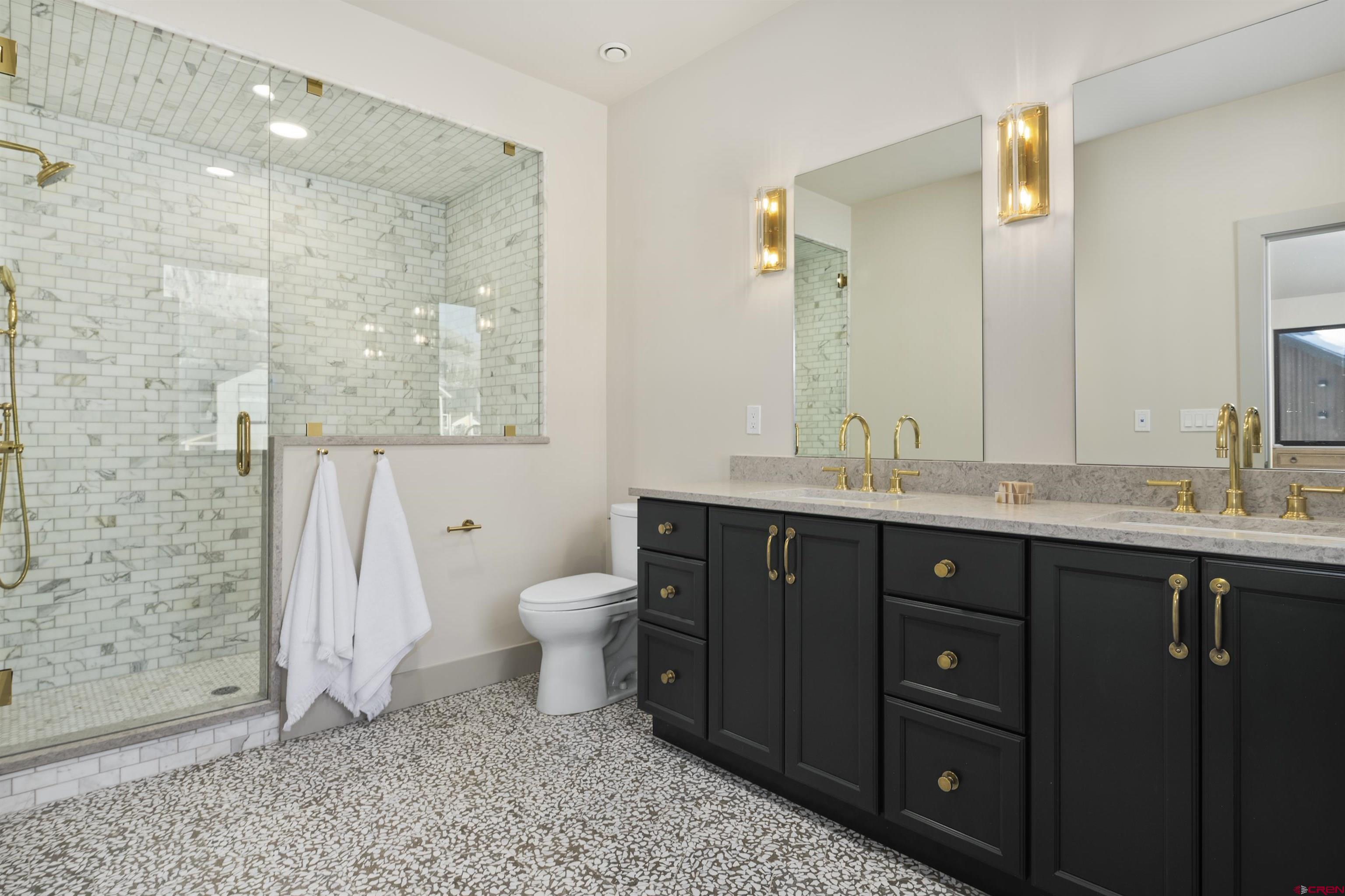 180 Elk Valley Road, Unit 118 Crested Butte, CO 81224 - Photo 22 of 39 a bathroom with a granite countertop sink toilet and shower