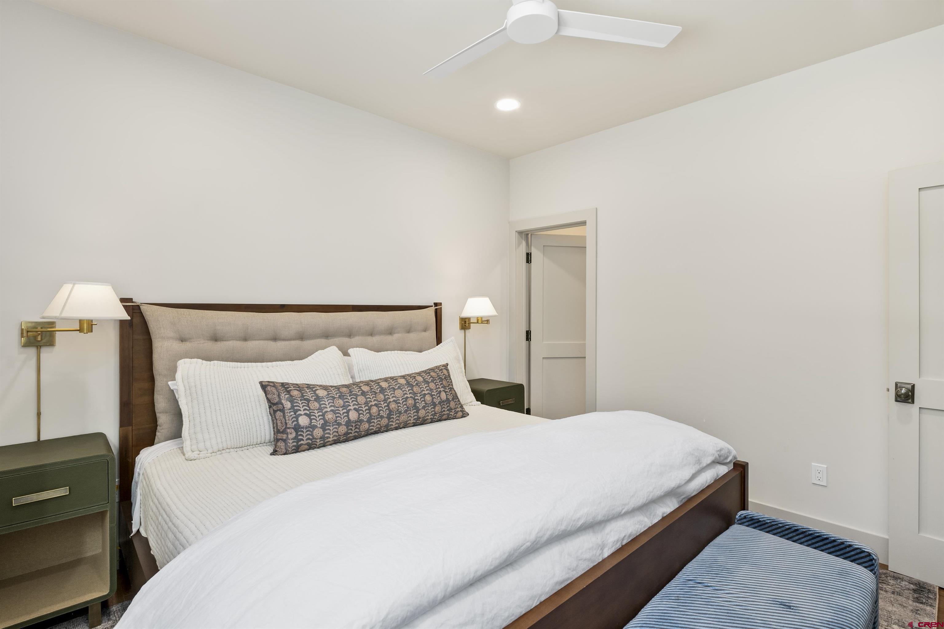 180 Elk Valley Road, Unit 118 Crested Butte, CO 81224 - Photo 27 of 39 a bedroom with a bed and a night stand