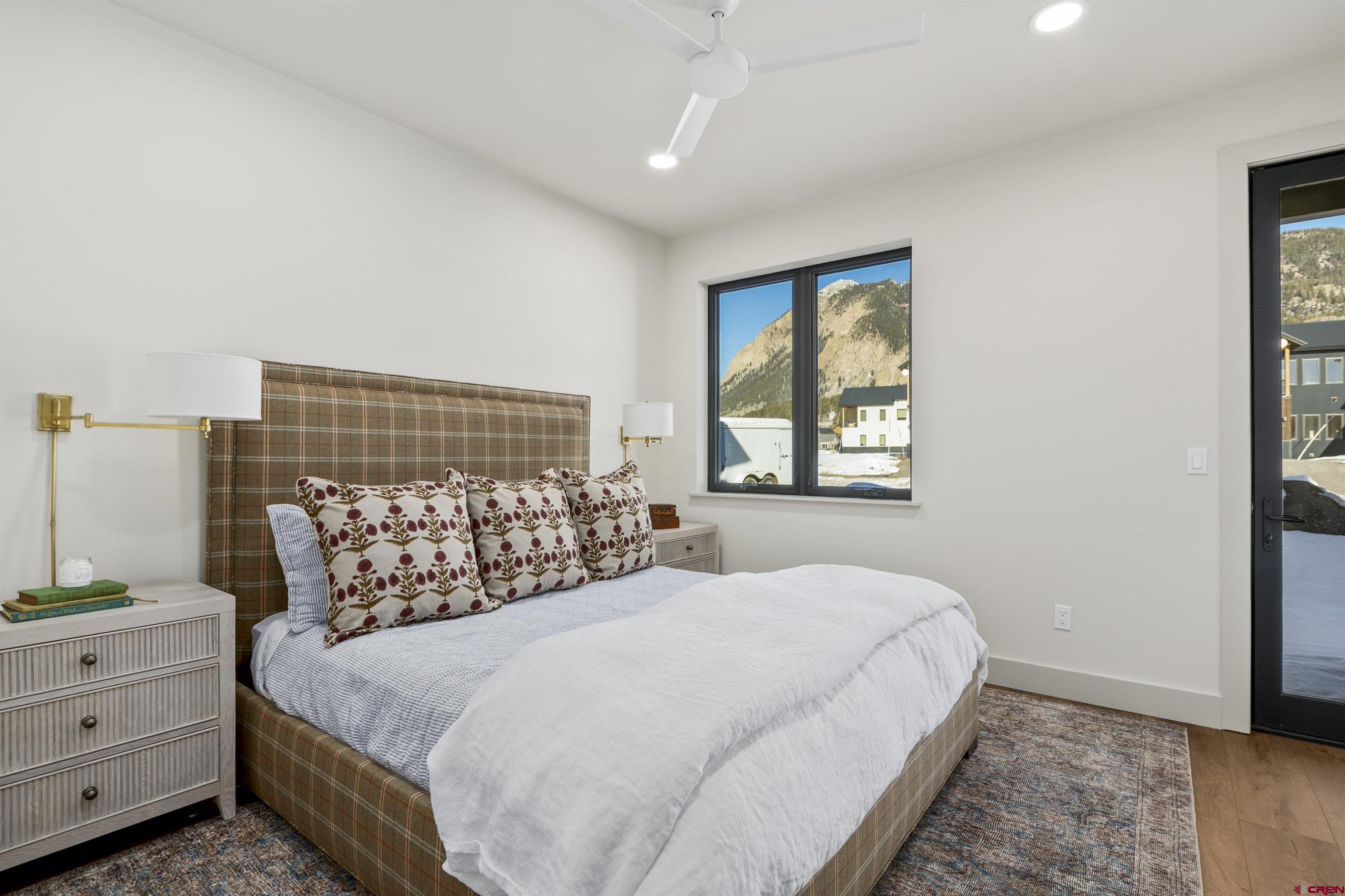 180 Elk Valley Road, Unit 118 Crested Butte, CO 81224 - Photo 29 of 39 a bed sitting in a bedroom next to a window