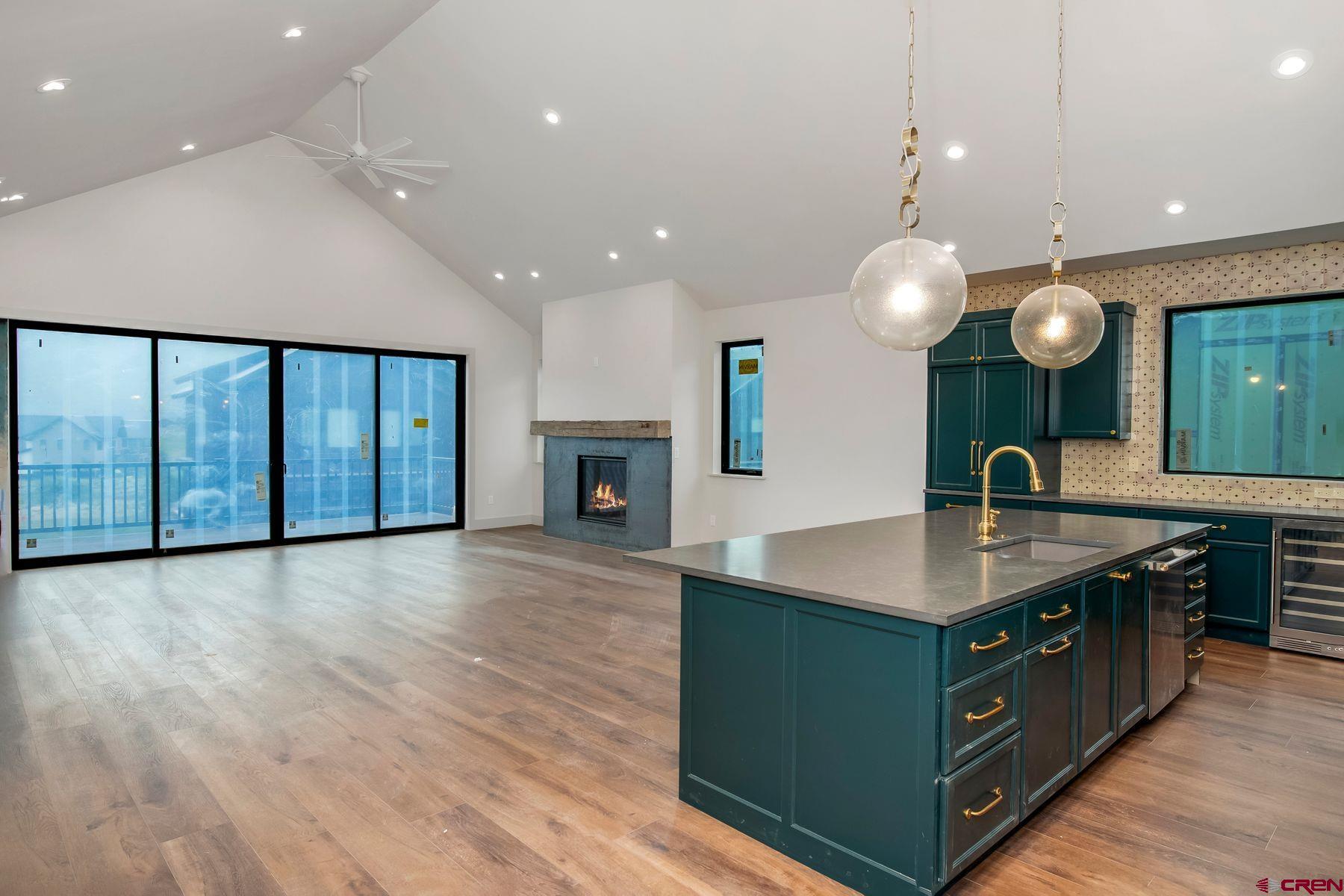180 Elk Valley Road, Unit 118 Crested Butte, CO 81224 - Photo 5 of 26 a kitchen with kitchen island a large counter top a sink and stainless steel appliances