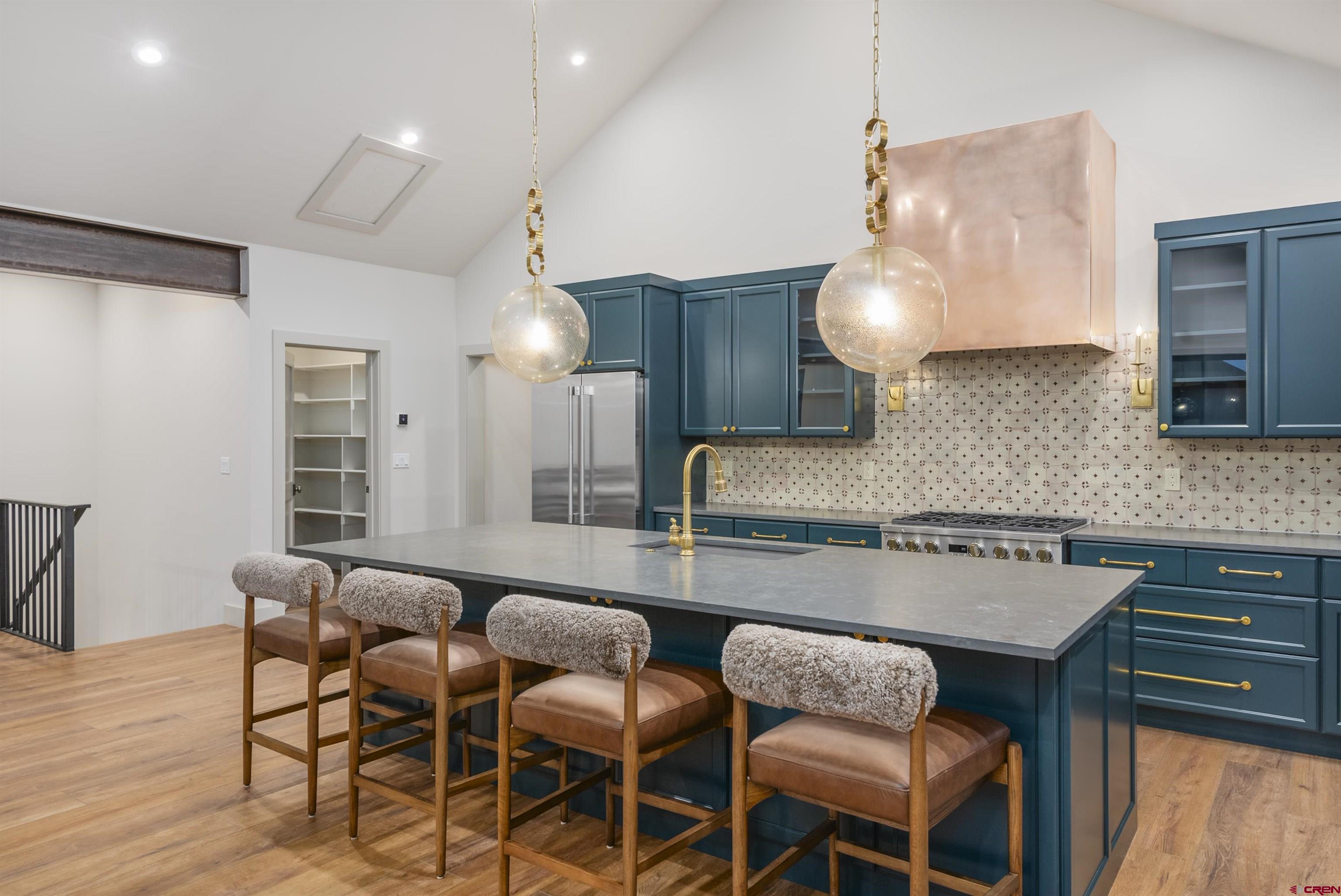180 Elk Valley Road, Unit 118 Crested Butte, CO 81224 - Photo 5 of 39 a kitchen with a dining table chairs and wooden floor