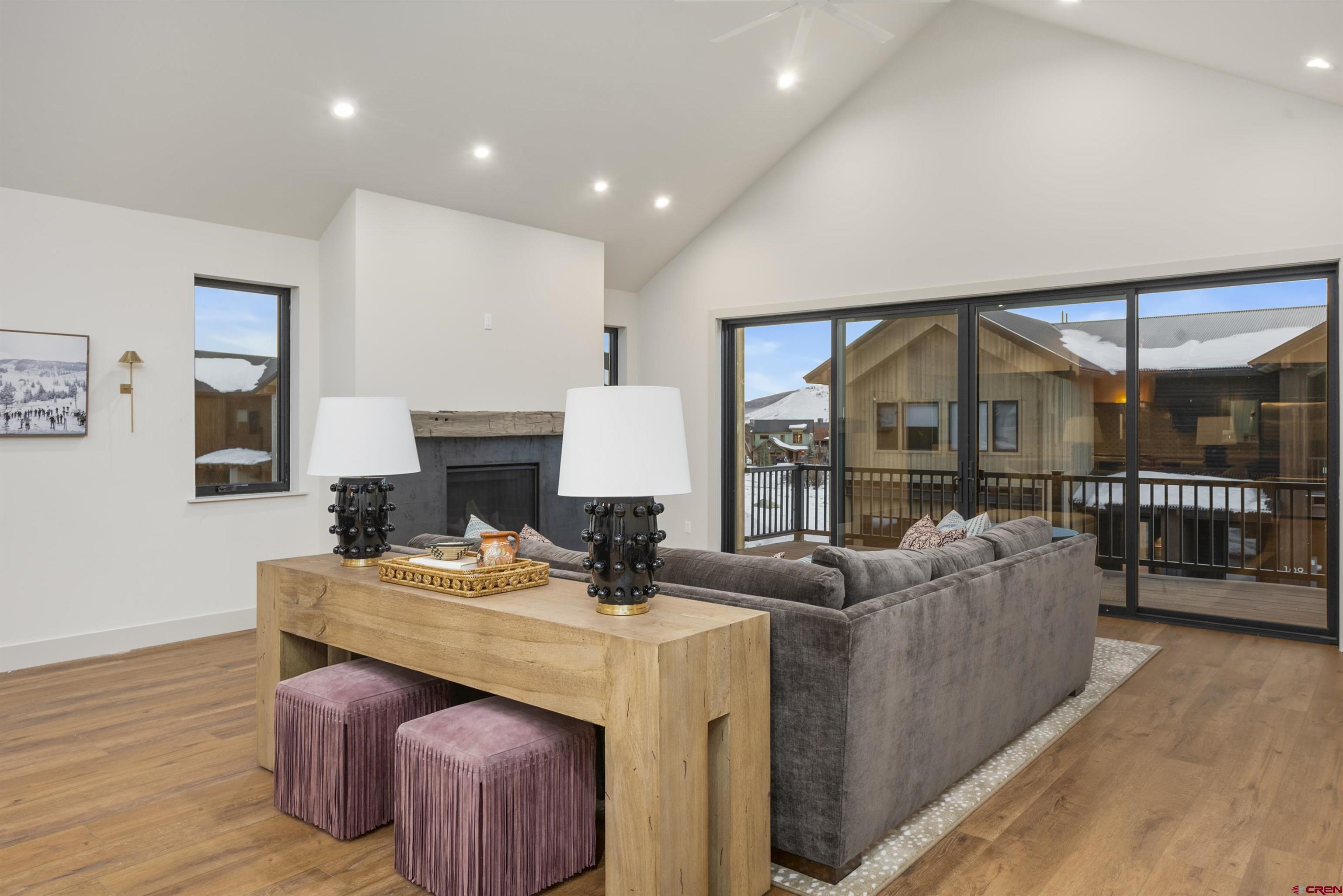 180 Elk Valley Road, Unit 118 Crested Butte, CO 81224 - Photo 10 of 39 a living room with fireplace furniture and a floor to ceiling window