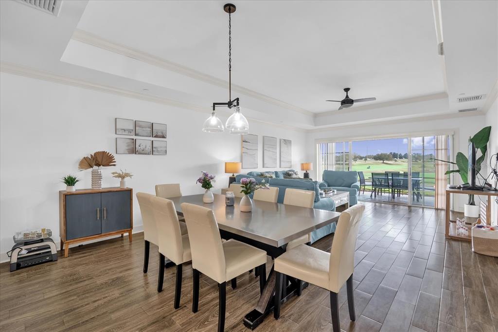 1362 Centre Ct Ridge Drive, Unit 102 Reunion, FL 34747 - Photo 3 of 35 a view of a dining room with furniture window and wooden floor
