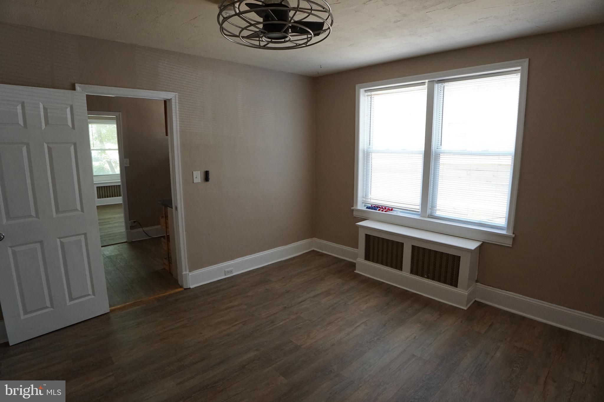2 Aigburth Road, Unit 1 Towson, MD 21286 - Photo 10 of 10 an empty room with wooden floor cabinet and windows