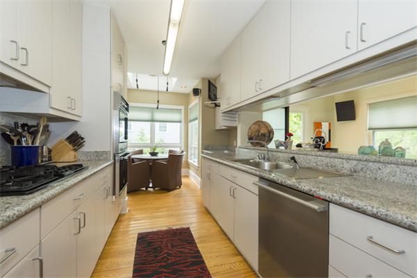 221 Reservoir Road Brookline, MA 02467 - Photo 8 of 30 a large kitchen with stainless steel appliances granite countertop a lot of counter space and a sink