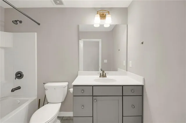a bathroom with a sink toilet vanity and tub