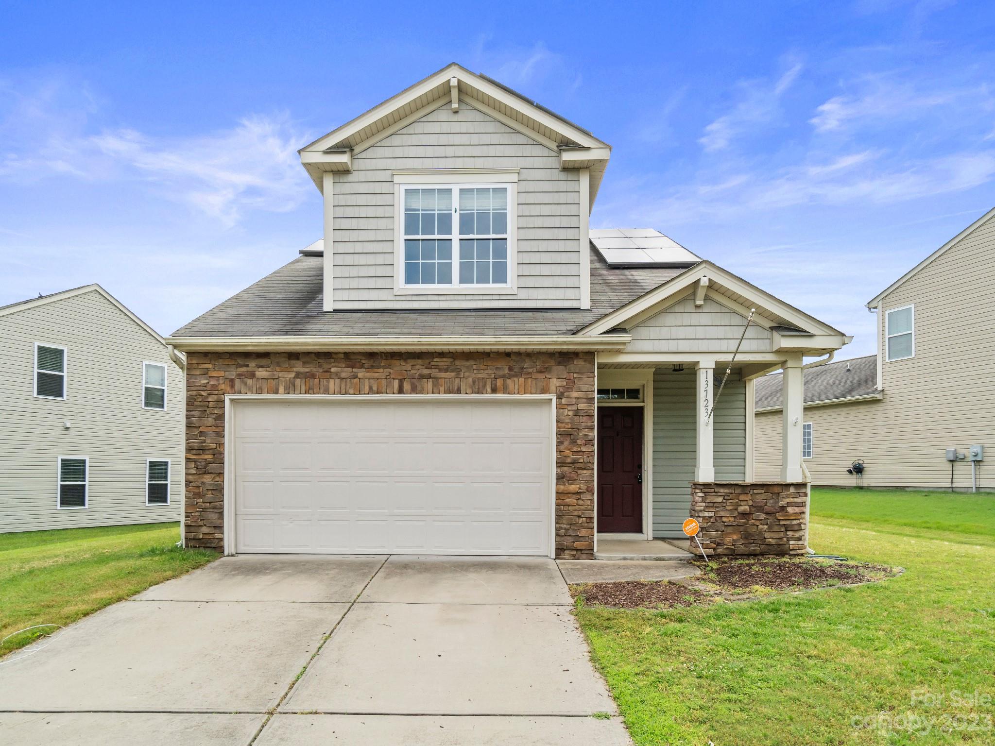 13723 Porter Creek Road Charlotte, NC 28262 - Photo 1 of 40 a front view of a house with a yard