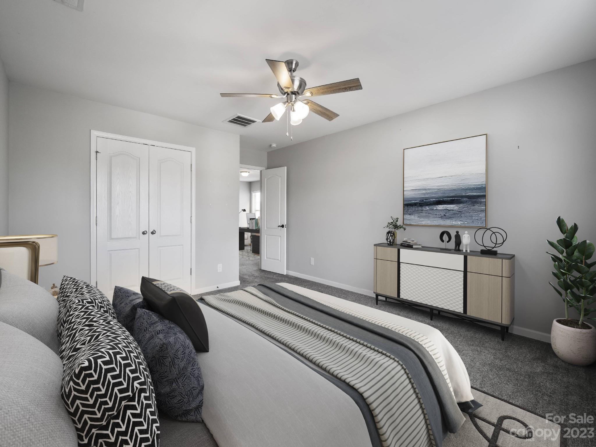 13723 Porter Creek Road Charlotte, NC 28262 - Photo 11 of 40 a bedroom with a bed and ceiling fan