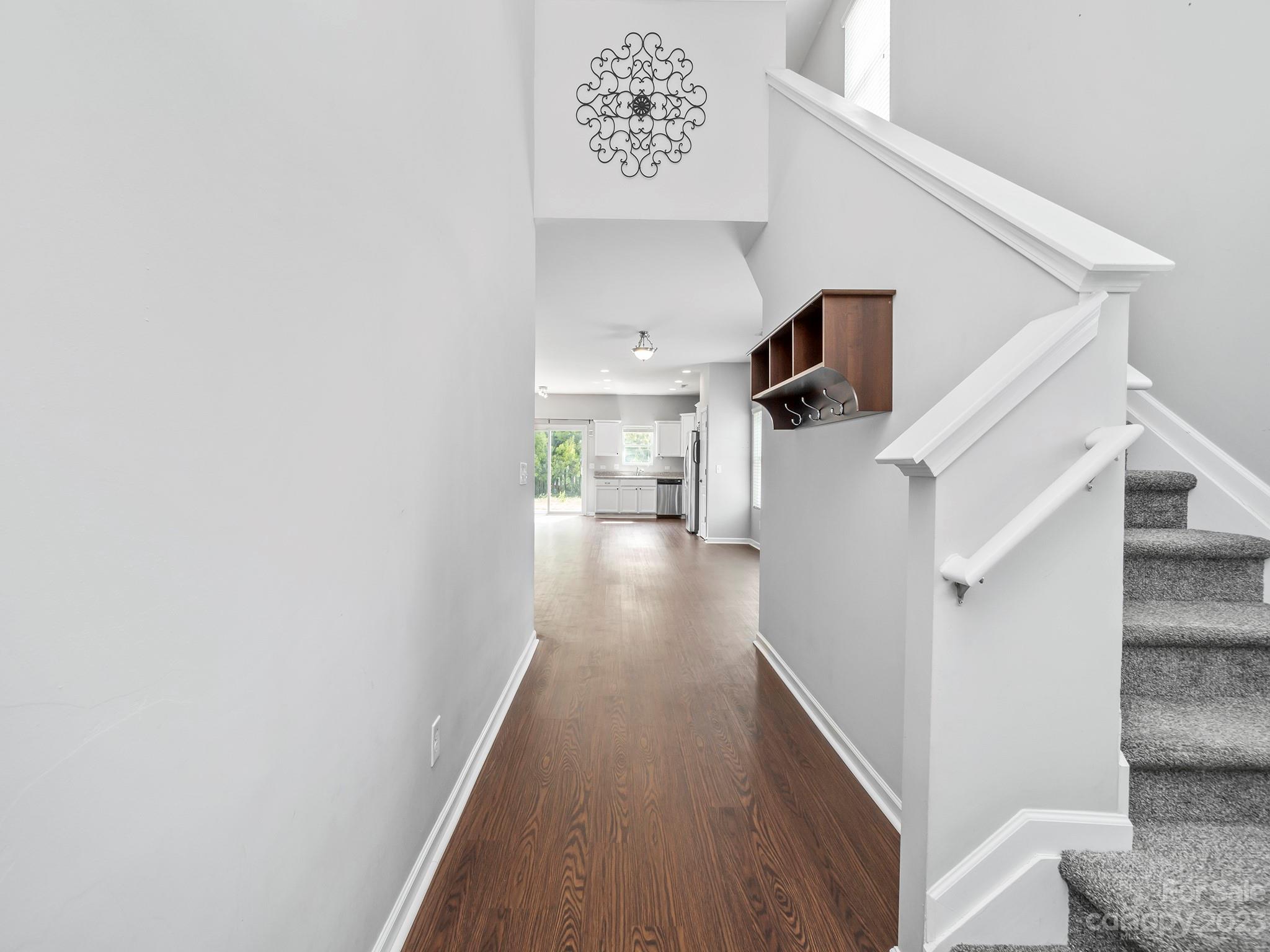 13723 Porter Creek Road Charlotte, NC 28262 - Photo 12 of 40 a view of a hallway with wooden floor and staircase