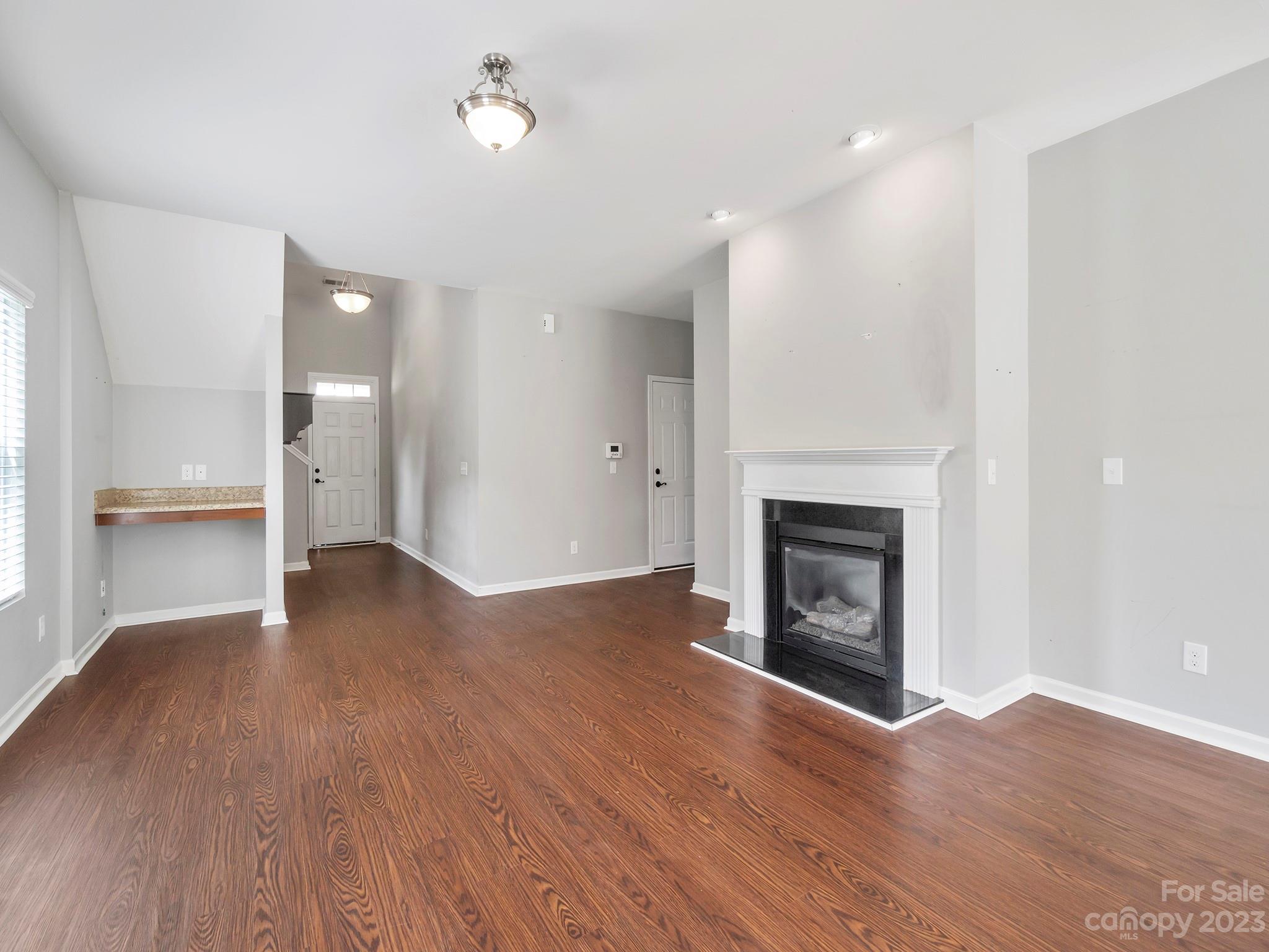 13723 Porter Creek Road Charlotte, NC 28262 - Photo 14 of 40 a view of a livingroom with wooden floor and a fireplace