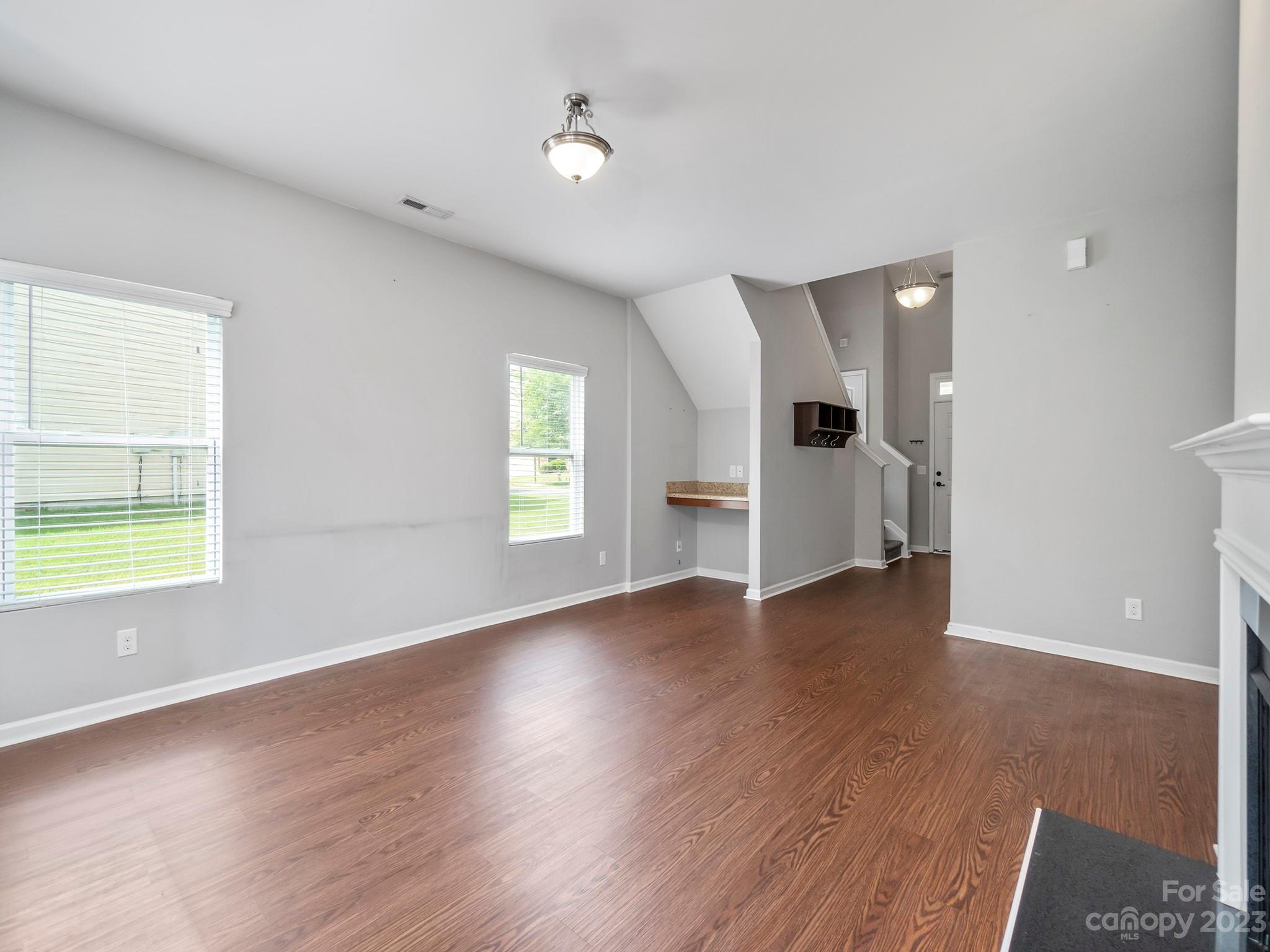 13723 Porter Creek Road Charlotte, NC 28262 - Photo 15 of 40 an empty room with wooden floor and windows