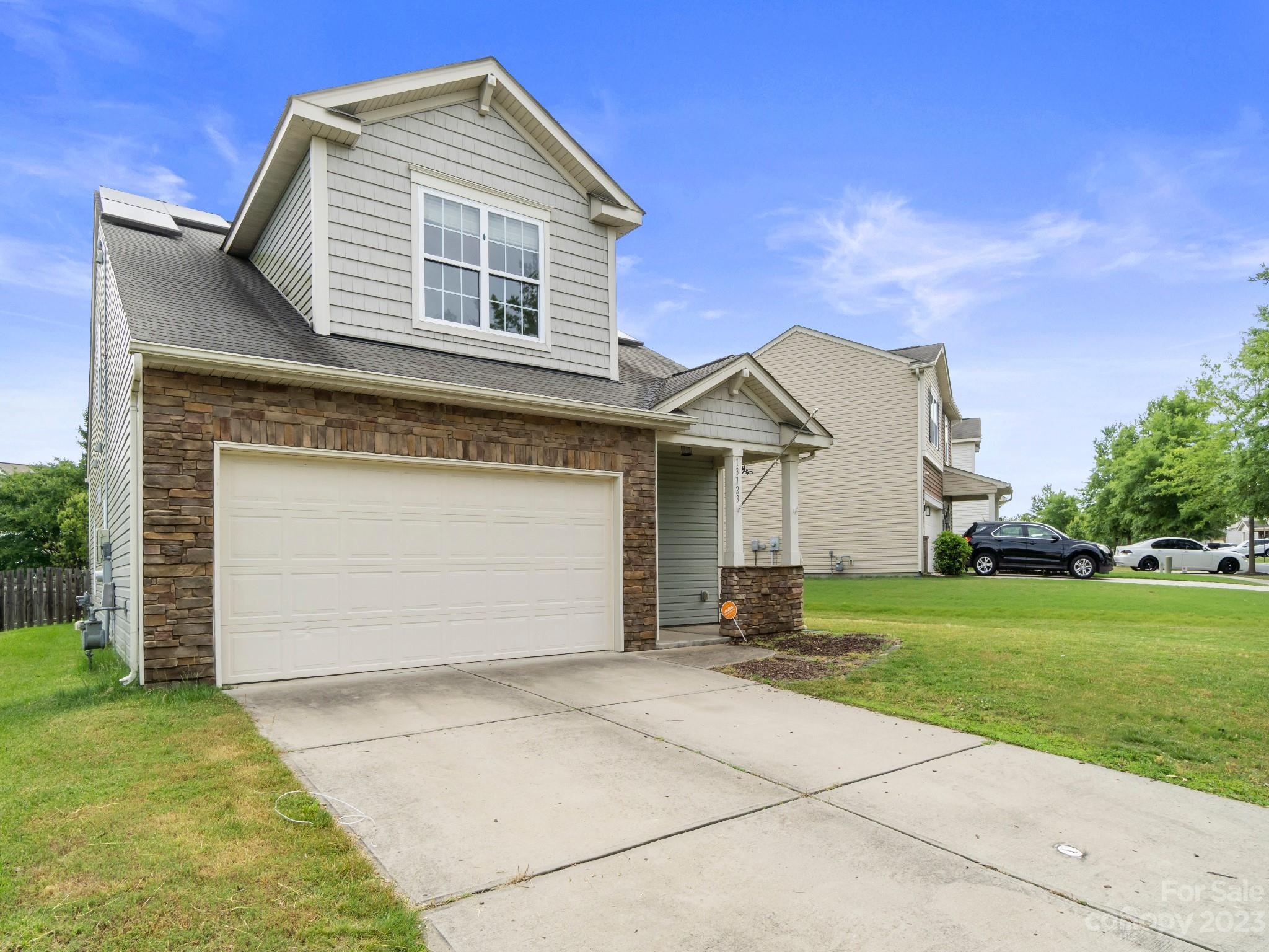 13723 Porter Creek Road Charlotte, NC 28262 - Photo 2 of 40 a front view of a house with a yard and garage