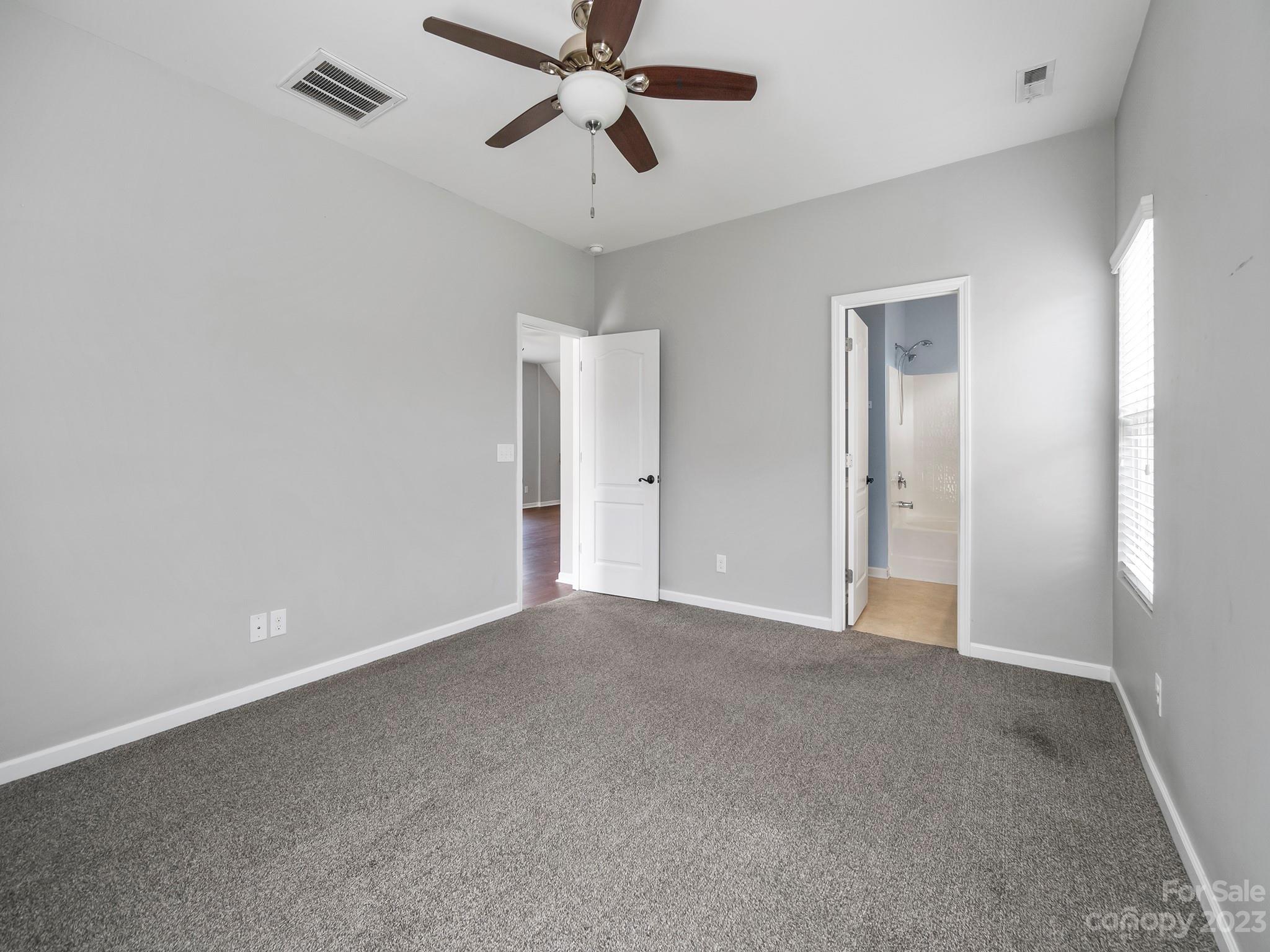 13723 Porter Creek Road Charlotte, NC 28262 - Photo 22 of 40 a view of an empty room and a ceiling fan