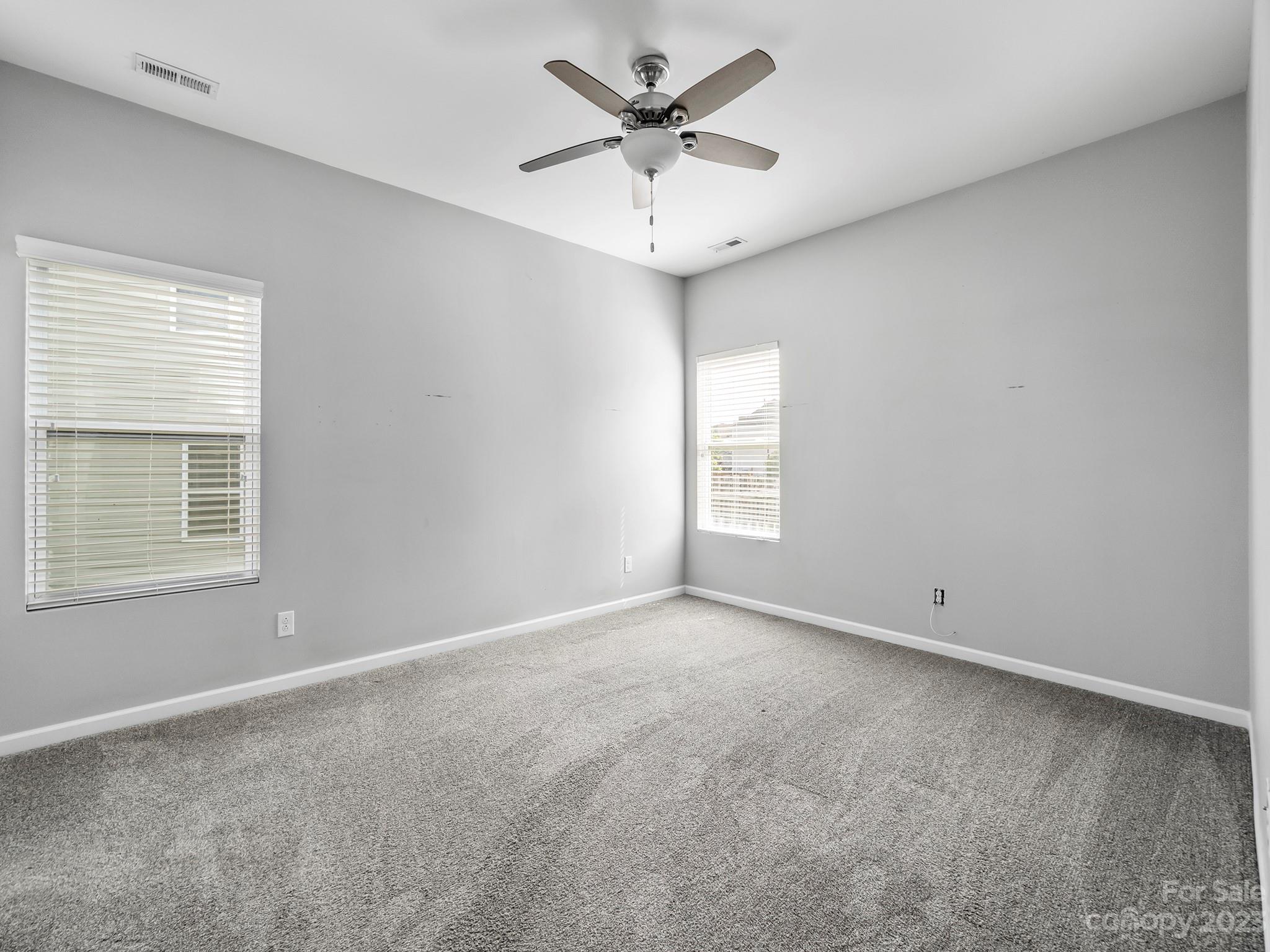 13723 Porter Creek Road Charlotte, NC 28262 - Photo 23 of 40 an empty room with a window and a ceiling fan