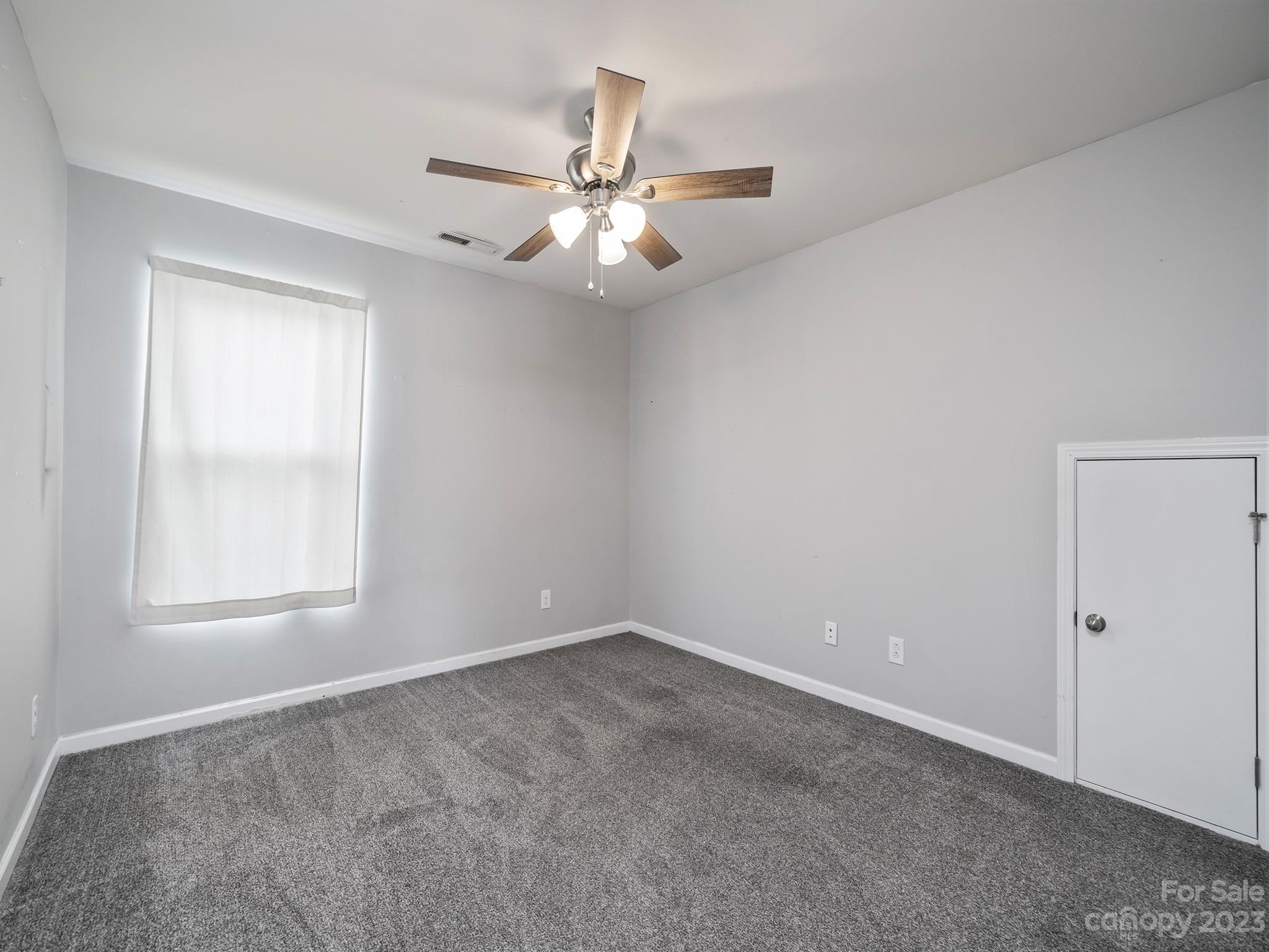 13723 Porter Creek Road Charlotte, NC 28262 - Photo 31 of 40 an empty room with windows and fan