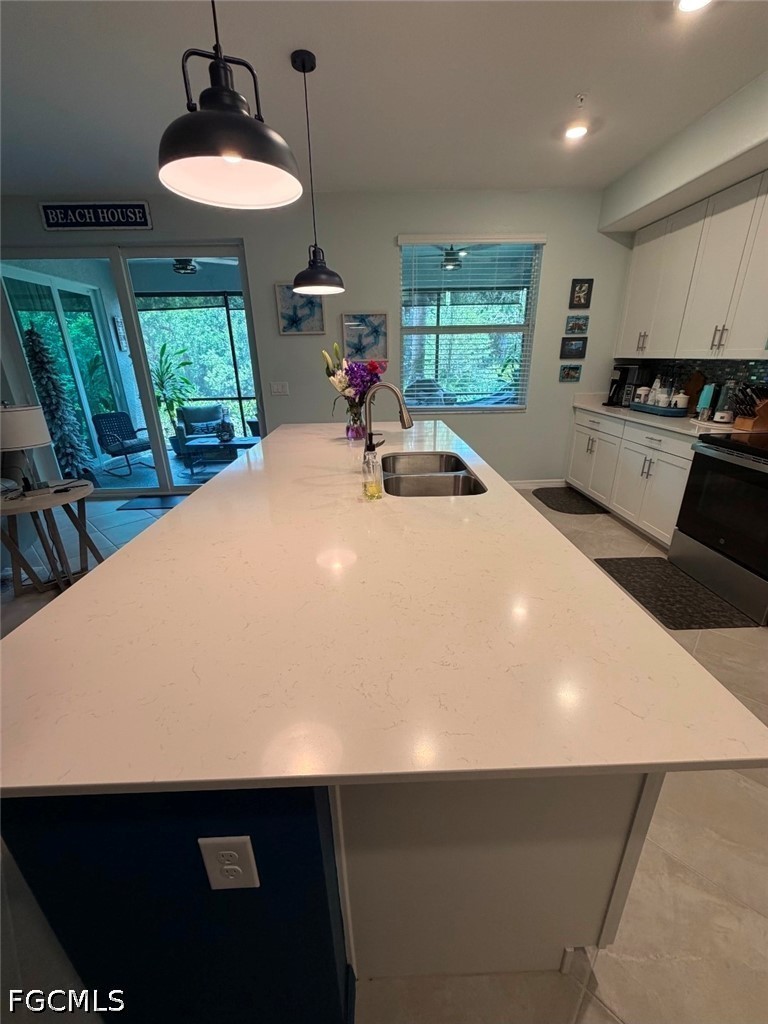 14191 Poppy Fld Loop, Unit 5312 Punta Gorda, FL 33955 - Photo 7 of 41 a kitchen with a sink a window and appliances