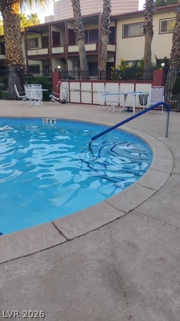 350 East Desert Inn Road, Unit B103 Las Vegas, NV 89109 - Photo 19 of 22 A refreshing community pool with ample lounge space set against a multi-story residence.