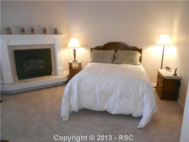 4827 Castledown Road Colorado Springs, CO 80917 - Photo 8 of 16 Master bedroom with gas fireplace