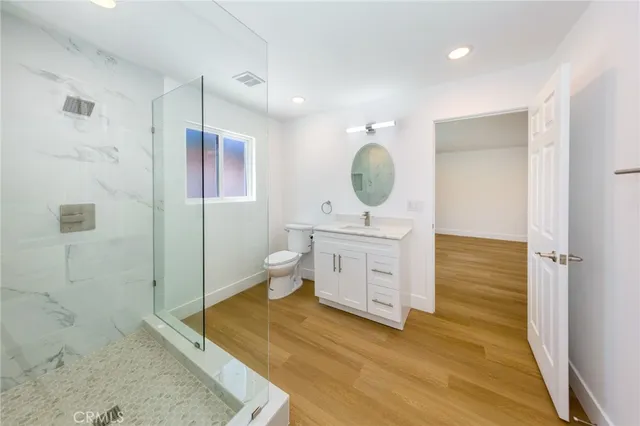 a spacious bathroom with a toilet sink and mirror