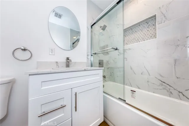 a bathroom with a double vanity sink mirror and bathtub