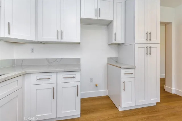a kitchen with white cabinets and a sink