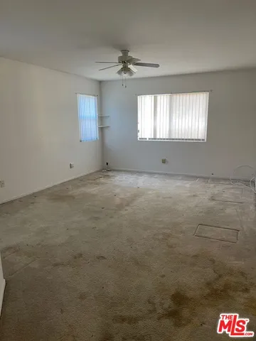 a view of an empty room and a window