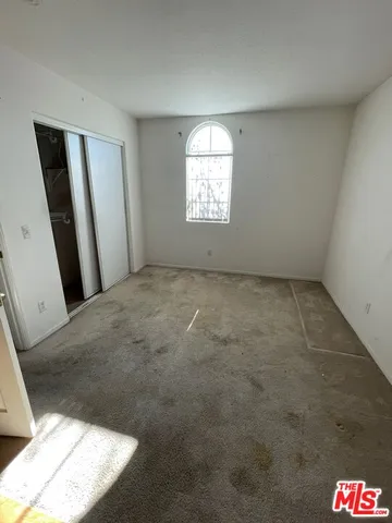 a view of an empty room and a window