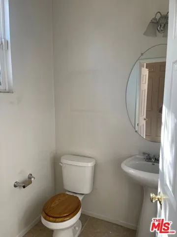 a white toilet sitting next to a bathroom sink