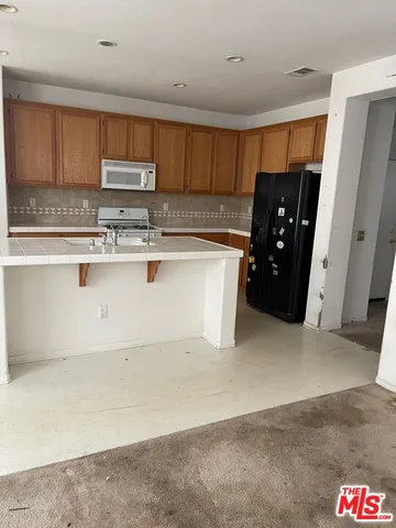 a kitchen with stainless steel appliances a refrigerator and stove