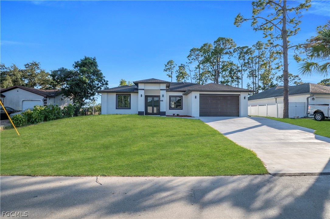 a view of a house with a yard and potted plants