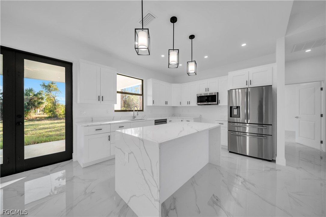 5003 2nd Street West Lehigh Acres, FL 33971 - Photo 5 of 21 a kitchen with refrigerator and window