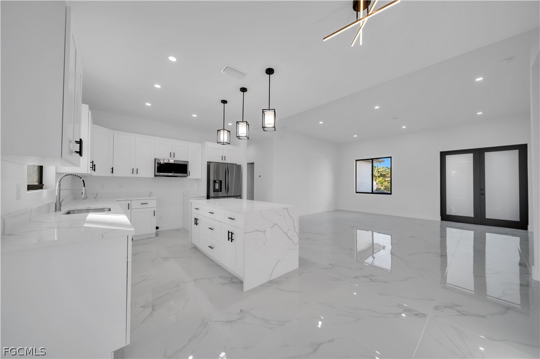 5003 2nd Street West Lehigh Acres, FL 33971 - Photo 6 of 21 a large white kitchen with cabinets