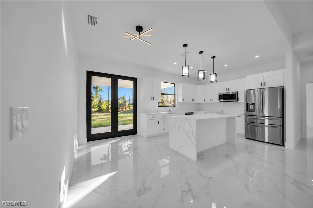 5003 2nd Street West Lehigh Acres, FL 33971 - Photo 7 of 21 a large white kitchen with a large window