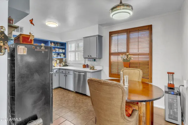 a kitchen with refrigerator cabinets and windows