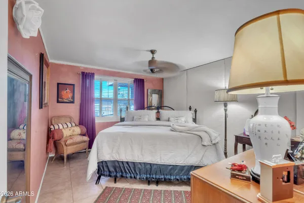 a bedroom with bed and window