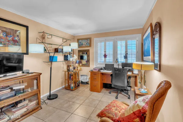 a view of a livingroom with workspace and a window