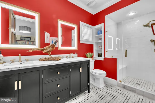 a bathroom with a granite countertop sink and a large mirror