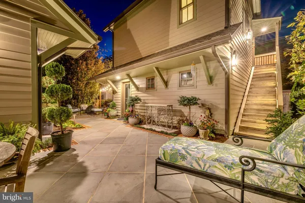 a view of a pathway of a house with flower plants