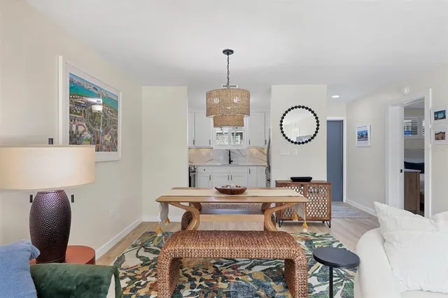 a bedroom with a bed lamp on desk and a window