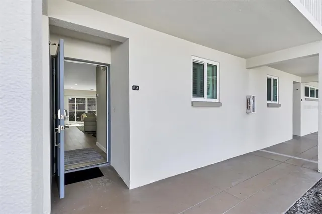 a view of a livingroom with furniture and mirror