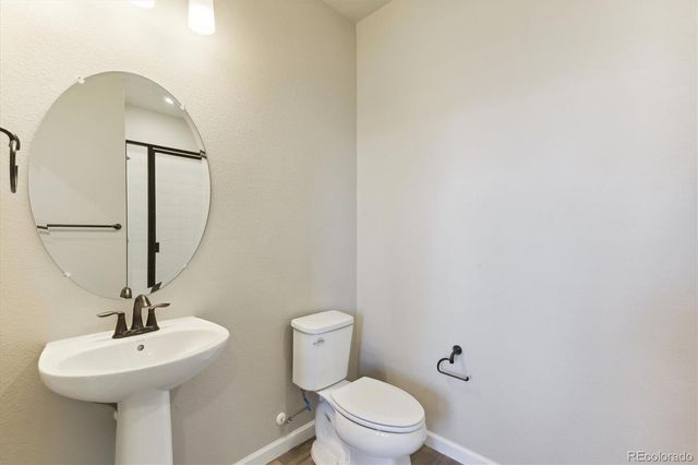 a large kitchen with kitchen island a large island in the center a sink stainless steel appliances and cabinets