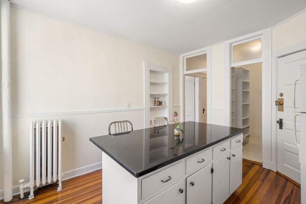 384 Riverway, Unit 5 Boston, MA 02115 - Photo 13 of 20 a bathroom with a granite countertop sink and a mirror