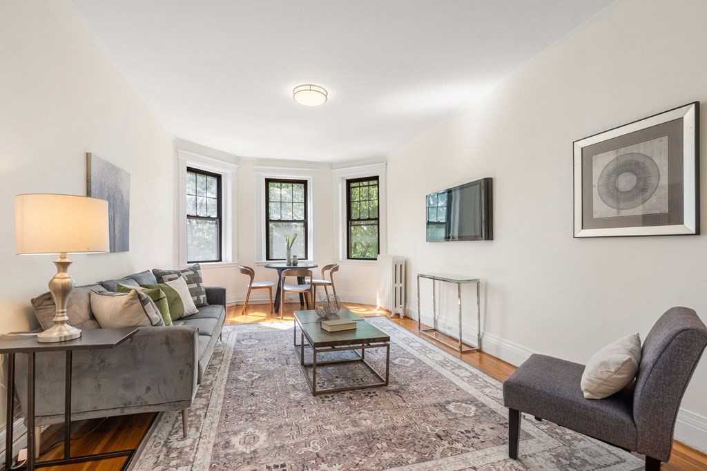 384 Riverway, Unit 5 Boston, MA 02115 - Photo 15 of 20 a living room with furniture and a lamp