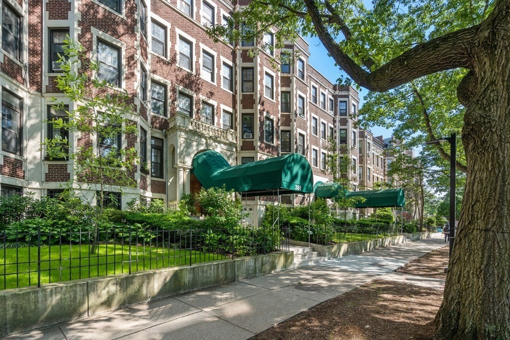 384 Riverway, Unit 5 Boston, MA 02115 - Photo 17 of 20 a view of a building with a yard
