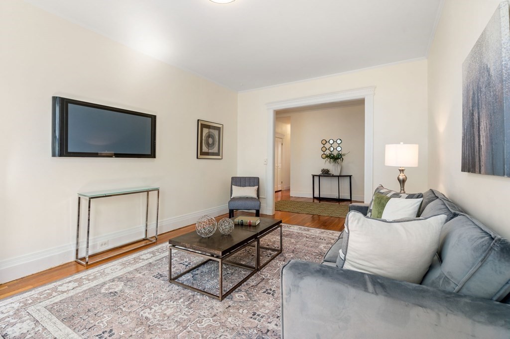 384 Riverway, Unit 5 Boston, MA 02115 - Photo 2 of 20 a living room with furniture and a flat screen tv