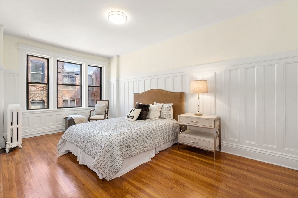 384 Riverway, Unit 5 Boston, MA 02115 - Photo 5 of 20 a bedroom with a bed and a large window