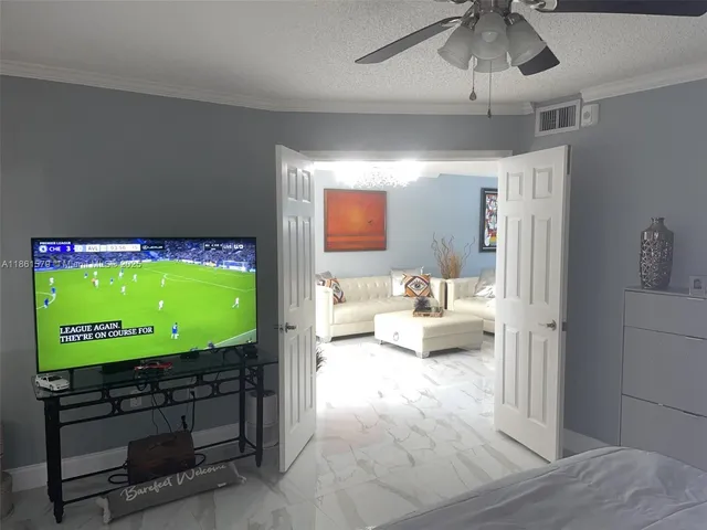 a bathroom with a glass door shower a sink and a toilet