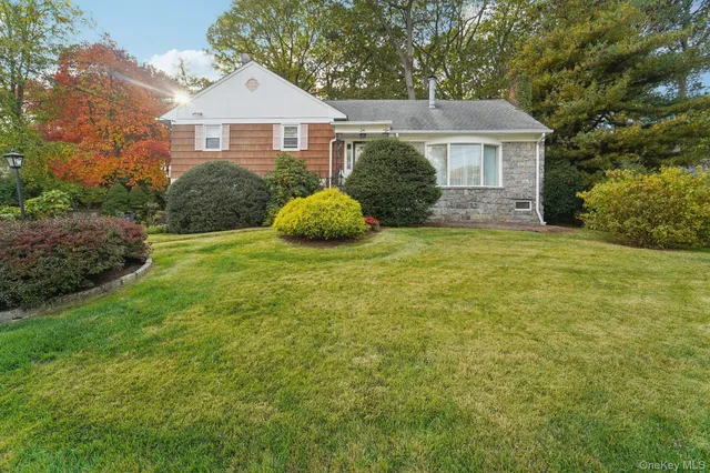 a view of a house with a yard and garage