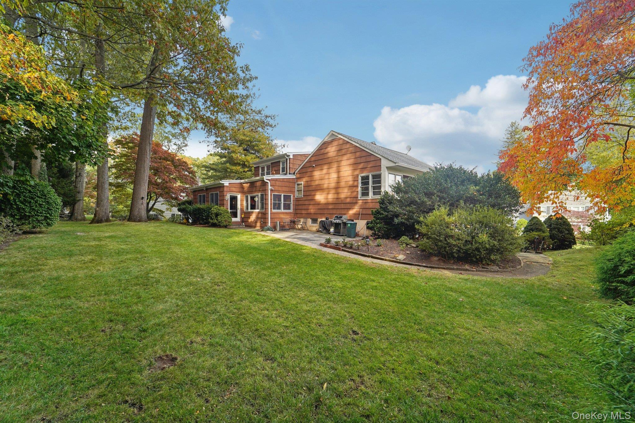 24 Pamela Lane New Rochelle, NY 10804 - Photo 25 of 34 a view of a house with a big yard and large trees
