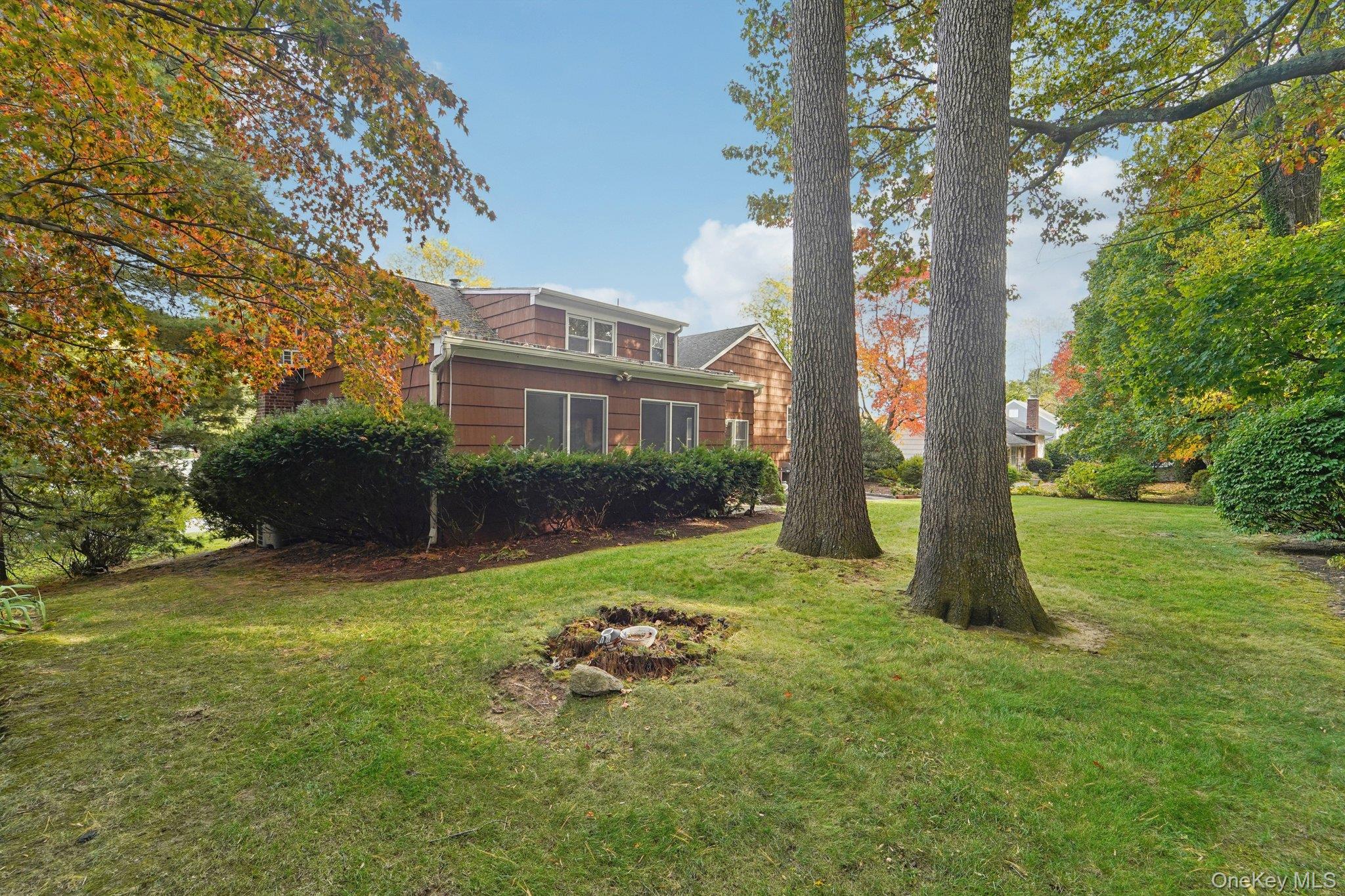 24 Pamela Lane New Rochelle, NY 10804 - Photo 26 of 34 a view of a garden with a house in the background